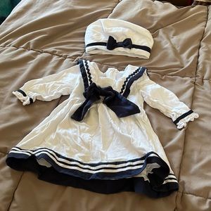 White baby girl’s sailors dress